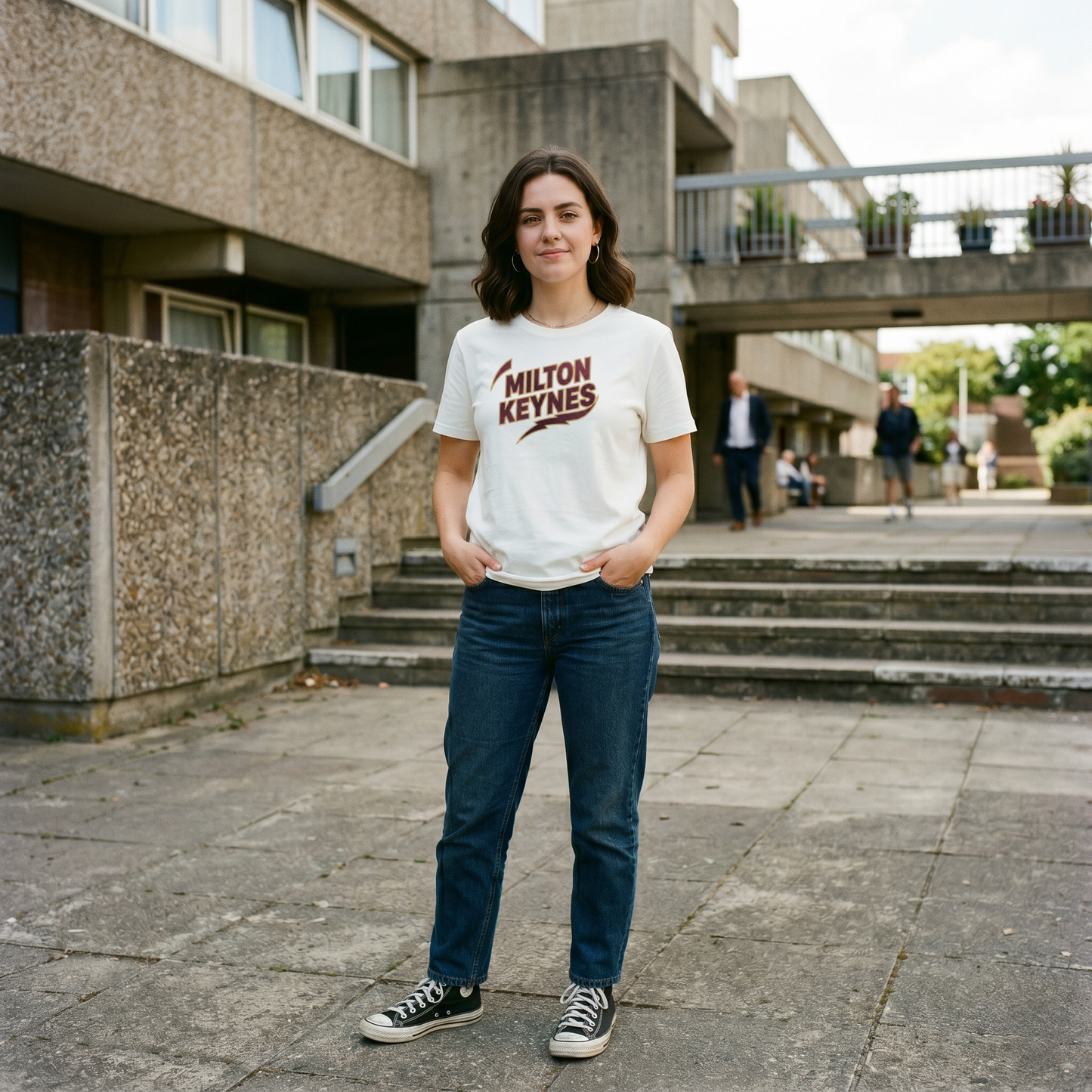 Graphic t-shirt featuring retro sports-style Milton Keynes text logo on a black background.