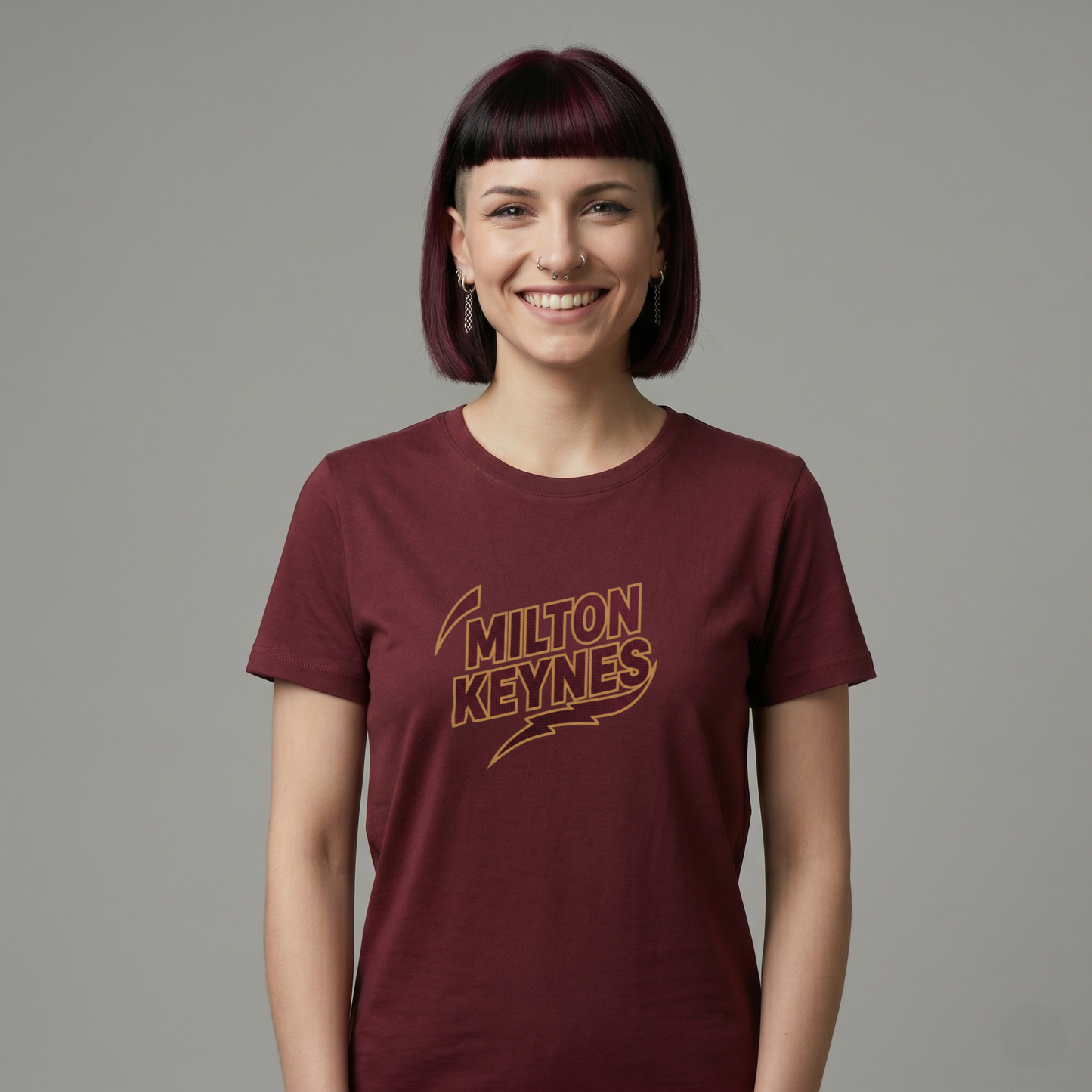 Graphic t-shirt featuring retro sports-style Milton Keynes text logo on a black background.