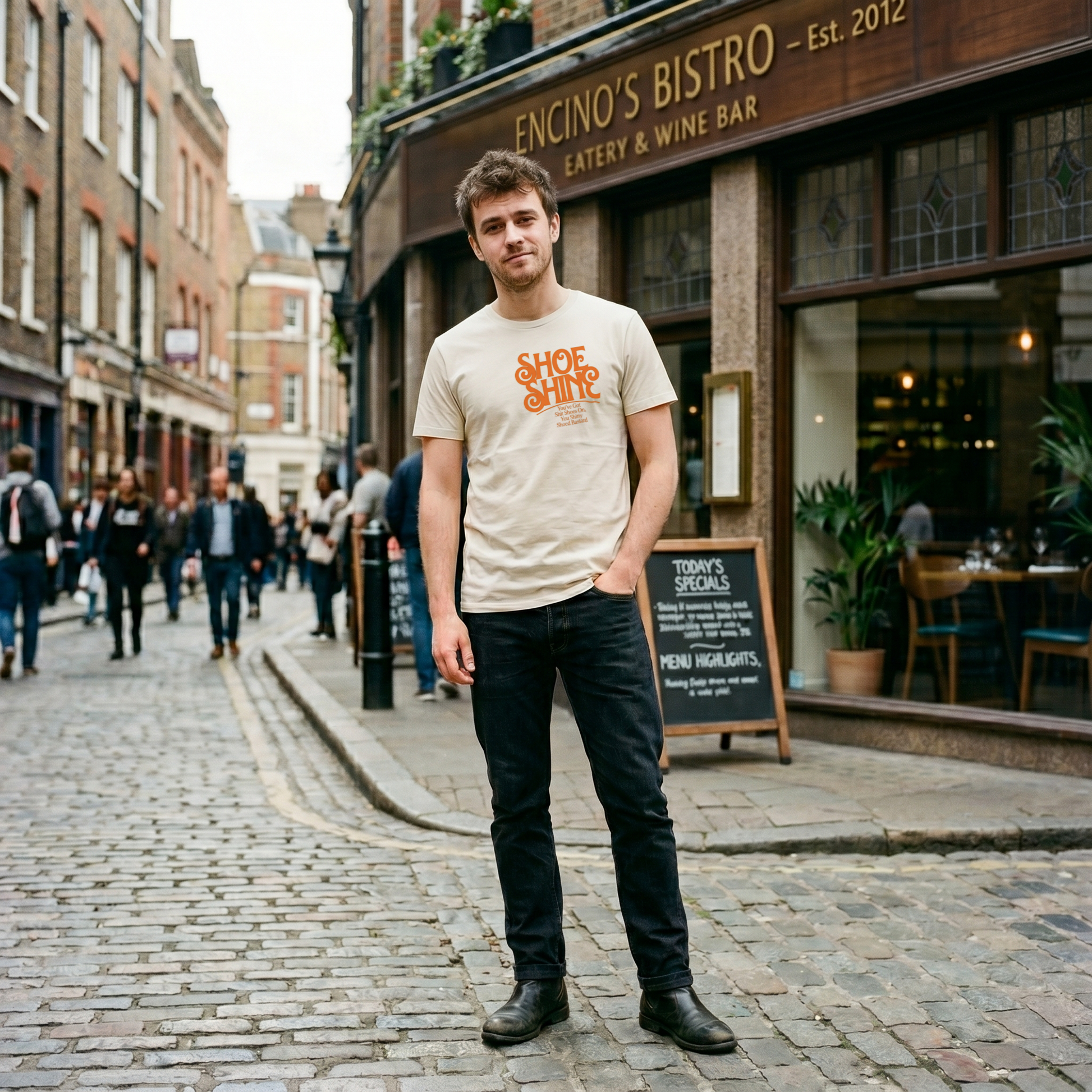 Retro orange typography on an organic t-shirt reading Shoe Shine and a funny British insult.